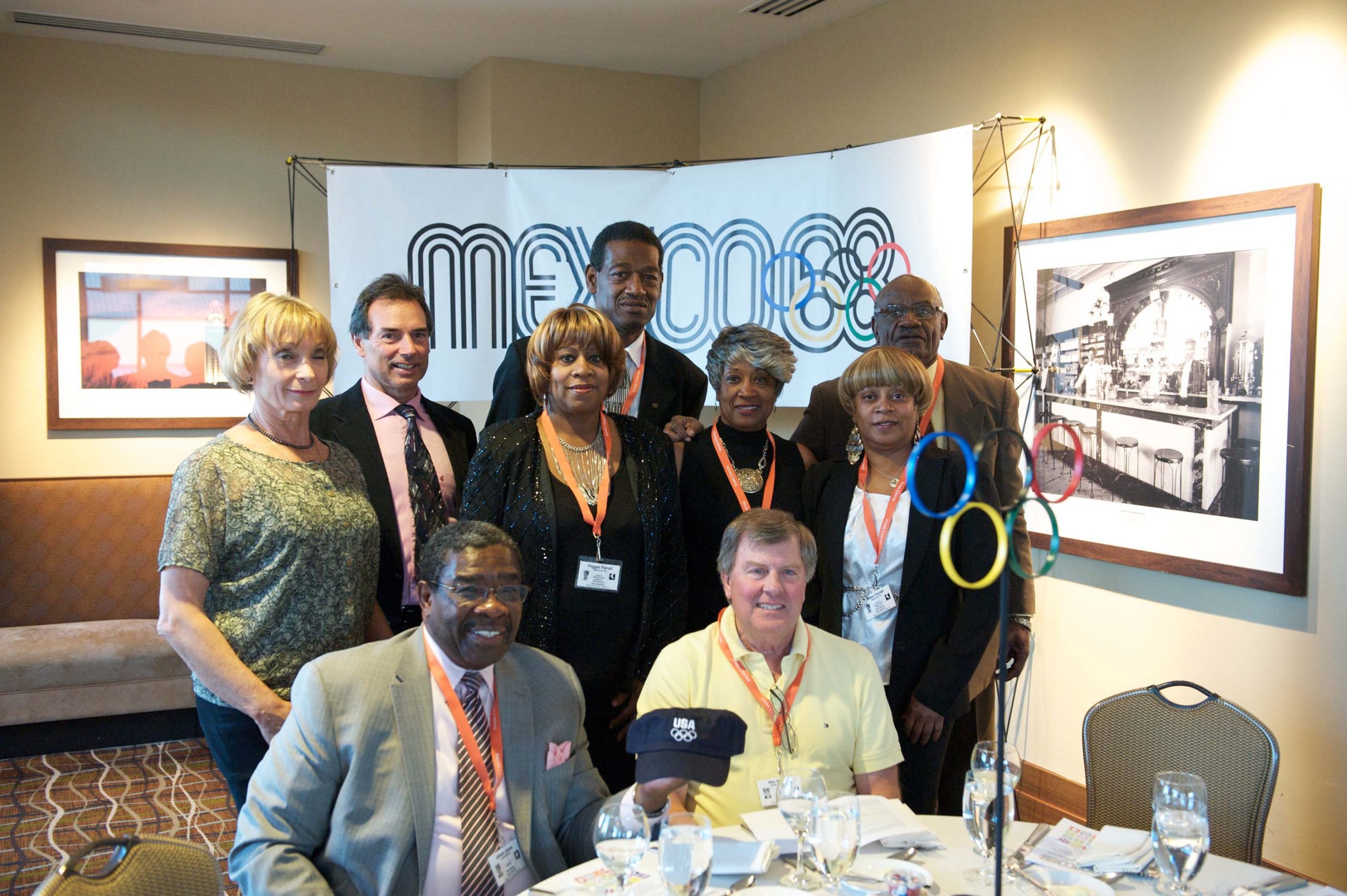 Nine people at a table at the 1968 U.S. Olympic Team 2012 Reunion.
