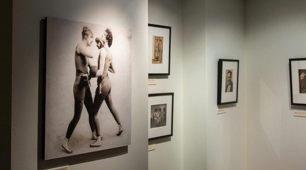 Five photographs of boxers, including one of a boxer punching another boxer in the face, from the Albert Davis Boxing and Sport Photography Collection, in a corner of the Golden Age of American Boxing Gallery.