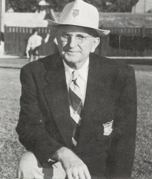 Former University of Texas track and field coach Clyde Littlefield with a hat and wearing a suit, likely from the Clyde Raab Littlefield Collection.
