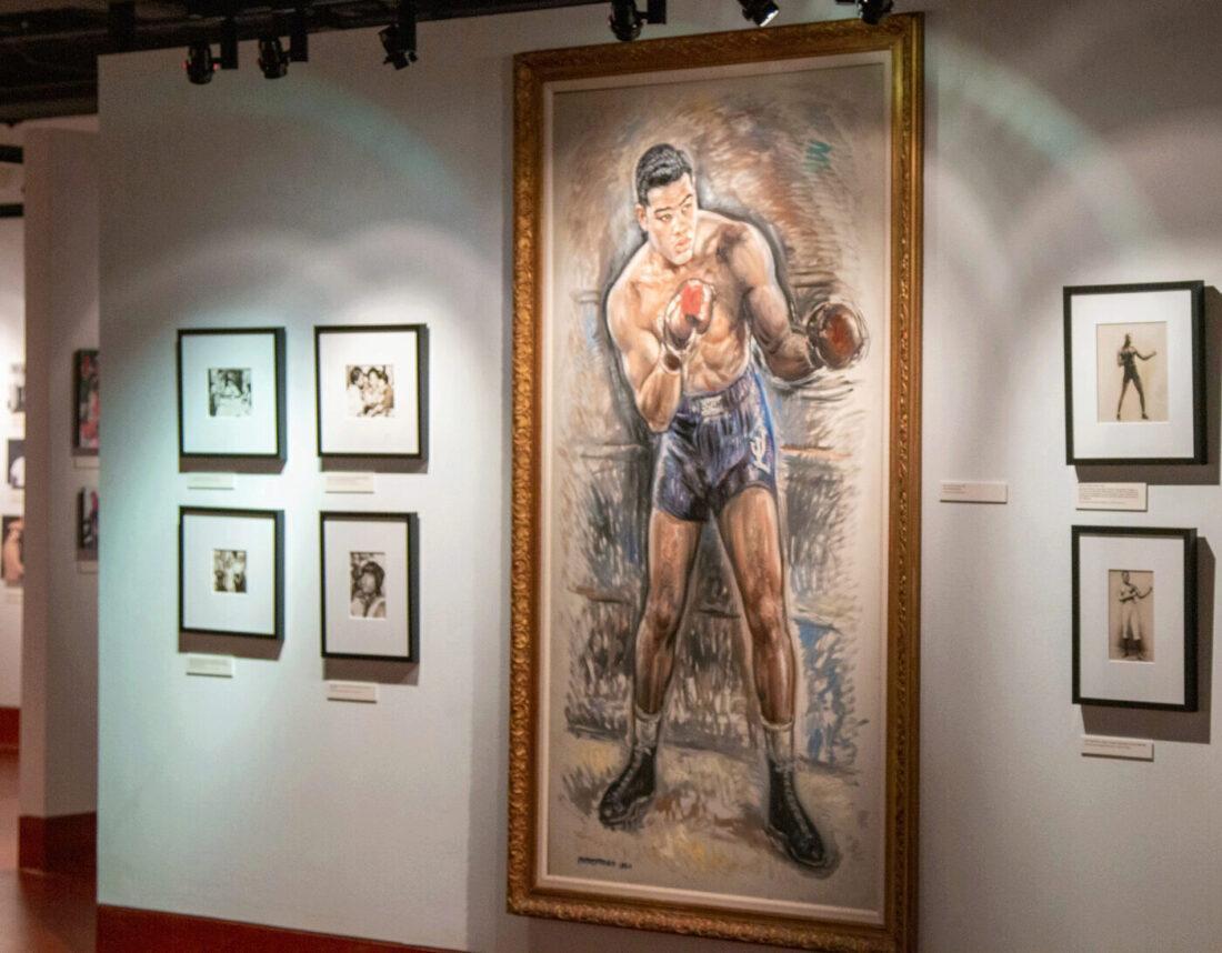 Painting of boxer Joe Louis and six photographs of boxers, from the Albert Davis Boxing and Sport Photography Collection, in the Golden Age of American Boxing Gallery.