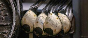 Four Ping golf clubs: a driver and 2, 3 and 4 woods, in the closed stacks room.