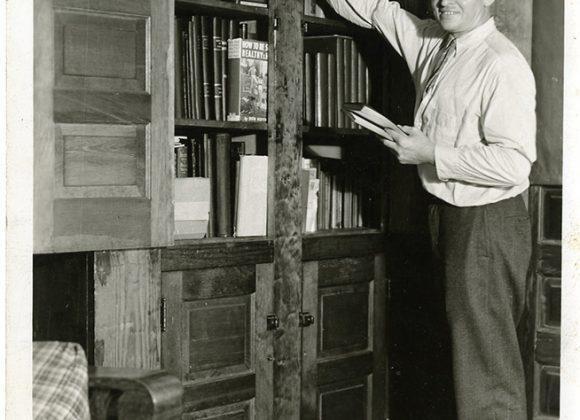 Strongman Ottley Coulter, with some of the books in his physical culture library, from the Ottley Coulter Collection.