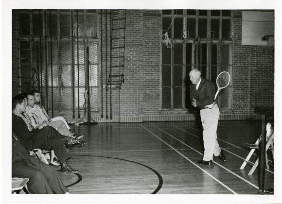 Former University of Texas tennis coach Wilmer Allison, giving a backhand demonstration, from the Wilmer Allison and Dave Snyder Tennis Collection.