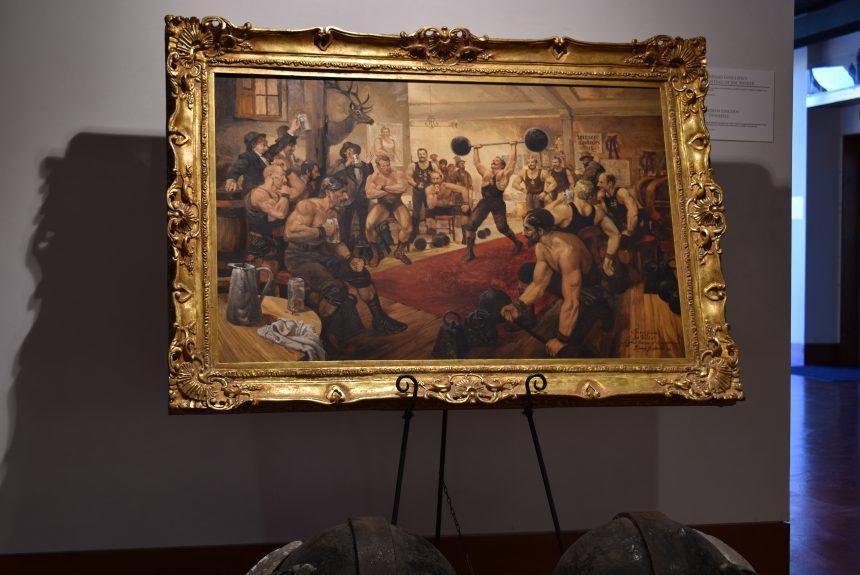Lorenzo Ghiglieri painting of a weightlifter in a tavern, with the face of publisher Joe Weider, from the Weider Art Collection, in the main lobby.