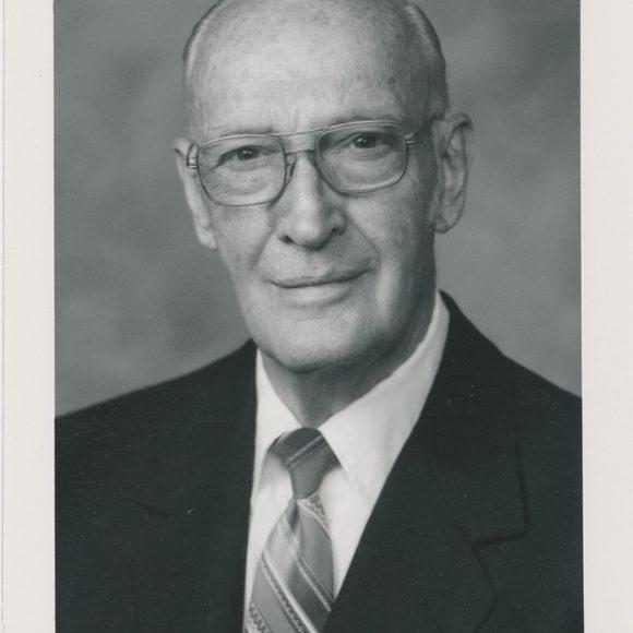 Headshot of IronMan magazine founder Peary Rader, in a suit, from the Peary and Mabel Rader Collection.
