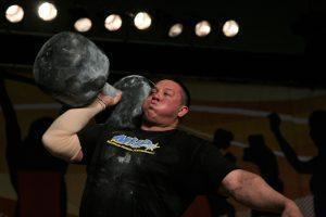 Strongman Mikail Koklyaev while pushing the 195 pound circus dumbbell overhead six times, at the Arnold (Schwarzenegger) Strongman Classic in 2006, in Columbus, Ohio