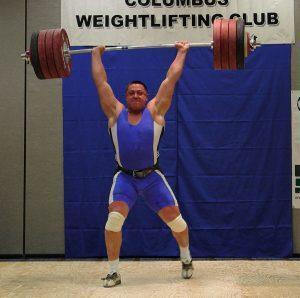 Mikhail Koklyaev jerking a 529 pound barbell overhead with two hands at the Arnold (Schwarzenegger) Strongman Classic in Columbus, Ohio