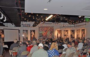 Jan Todd speaking to the 1968 U.S. Olympic Team Reunion audience in the Stark Center lobby.