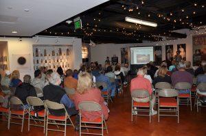 Dr. Tommy Hunt giving his presentation to the 1968 Olympic Team Reunion audience in the Stark Center lobby.