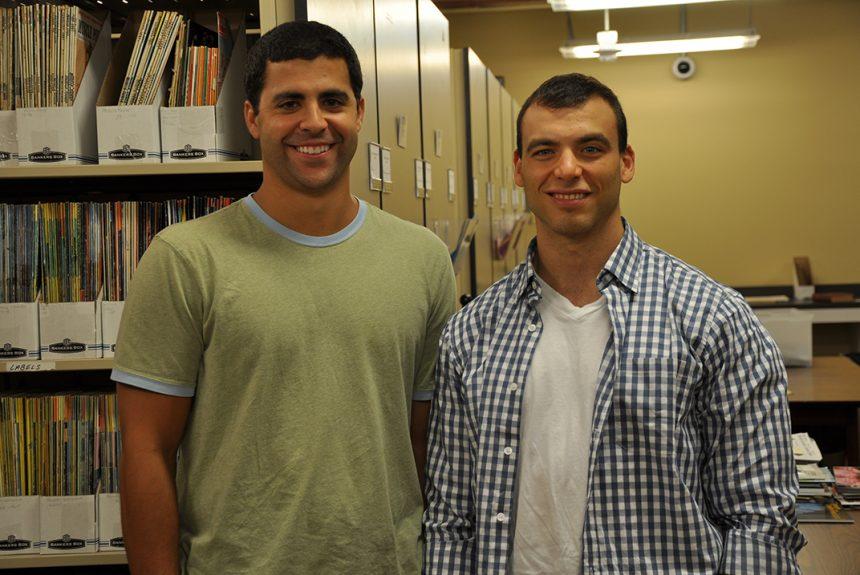 Former doctoral students Dominic Morais, left, and Ben Pollack, right, pose for a photograph in the Stark Center's archives.