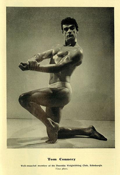 Sean Connery as a young bodybuilder, kneeling pose, flexing arms, chest, and left leg.