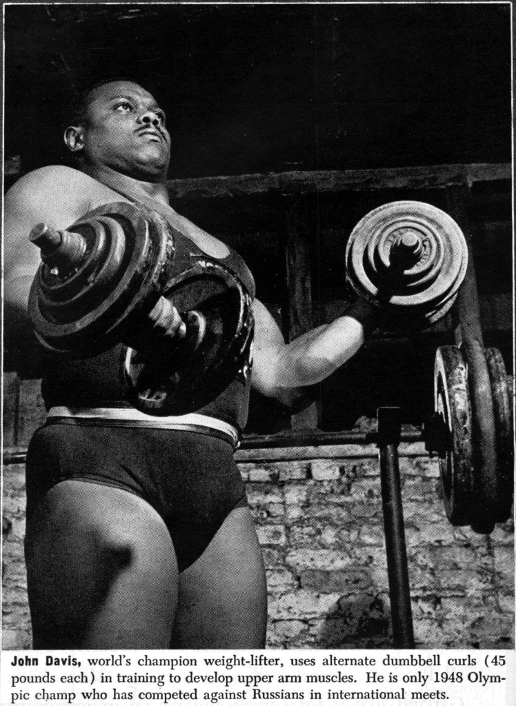 John Davis curling dumbbells in a photo for Ebony Magazine, May 1952.