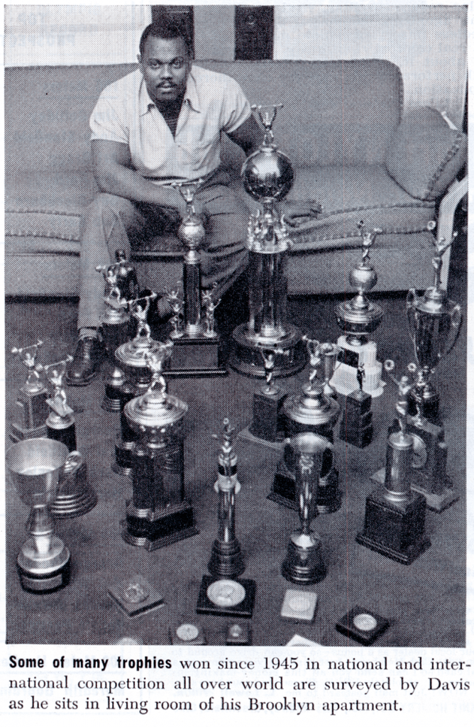 John Davis photographed with trophies for Ebony Magazine, May 1952.