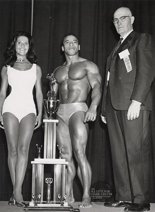 Chris Dickerson (center) posing with his 1970 Mr. America trophey along side Peary Rader (right) and Christine Zane (left)