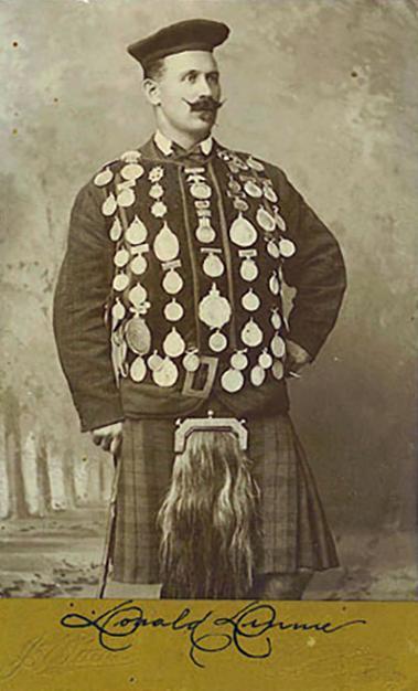 Cabinet card showing Donald Dinnie wearing his vest decorated with the medals he won in his career.
