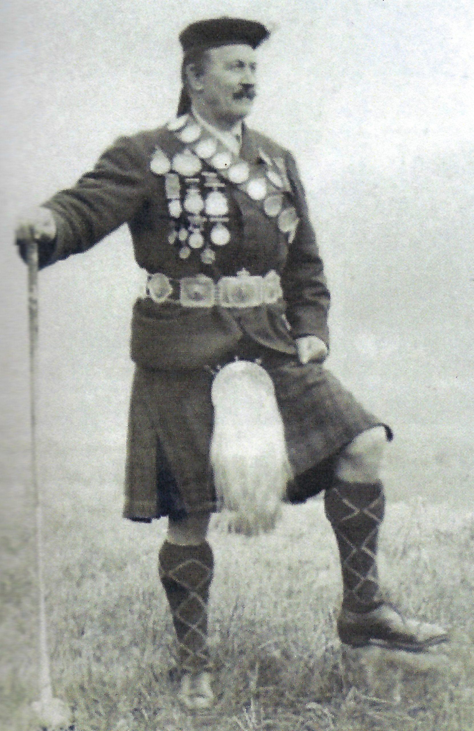 A photo of the athlete Donald Dinnie in kilt, coat, and hat.
