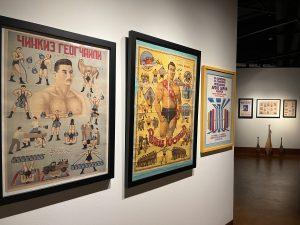 View of the Stark* Art exhibit showing posters featuring various strength feats
