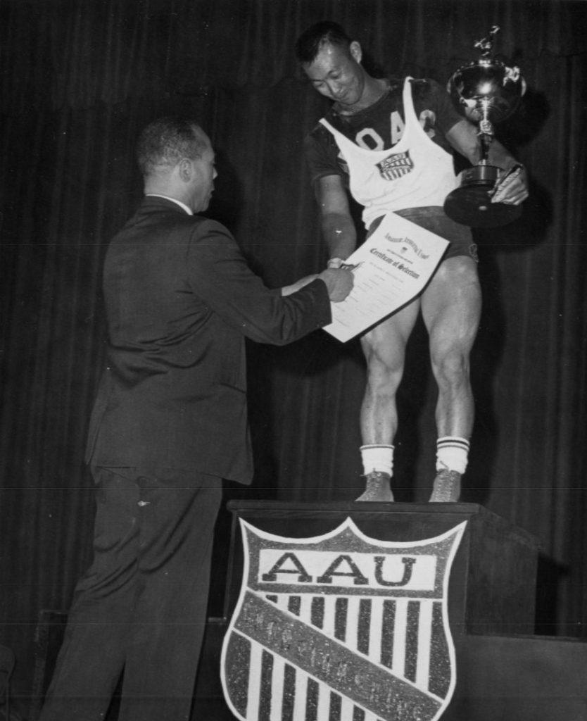 Walter Imahara receives All-American 1966 Certificate from Rudy Sablo.
