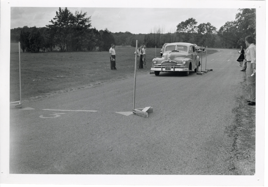 This photograph from 1947 depicts an automobile on the road in use for a drivers education course taught by Shorty Alderson.