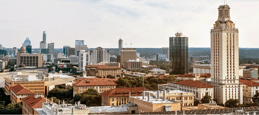 A color photograph showcasing the Austin skyline from the UT campus. Most prominently in view is the famous UT Tower.