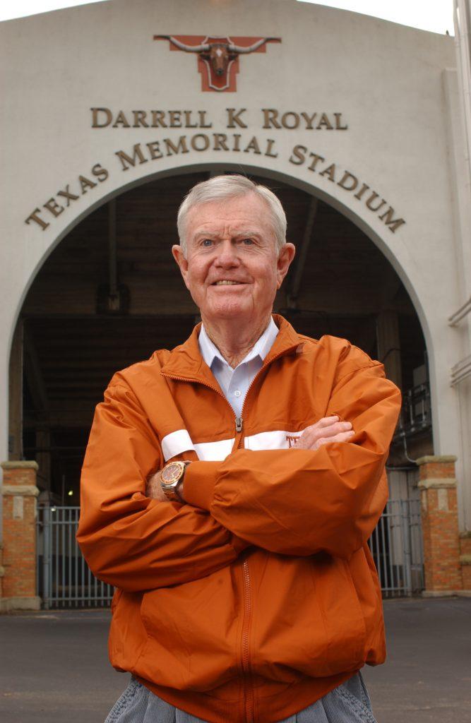 Darrell Royal stands in front of Texas Memorial Stadium where they have added his name Darrell K Royal.