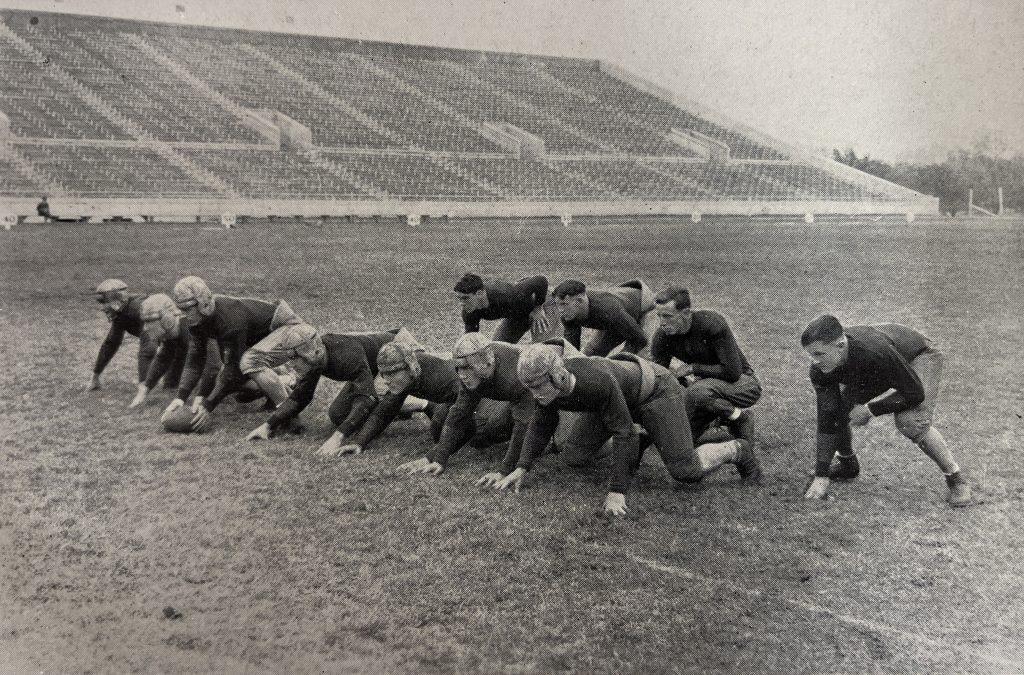 A black and white photo of the 1925 Texas Longhorn football team practicing inside Texas Memorial Stadium.