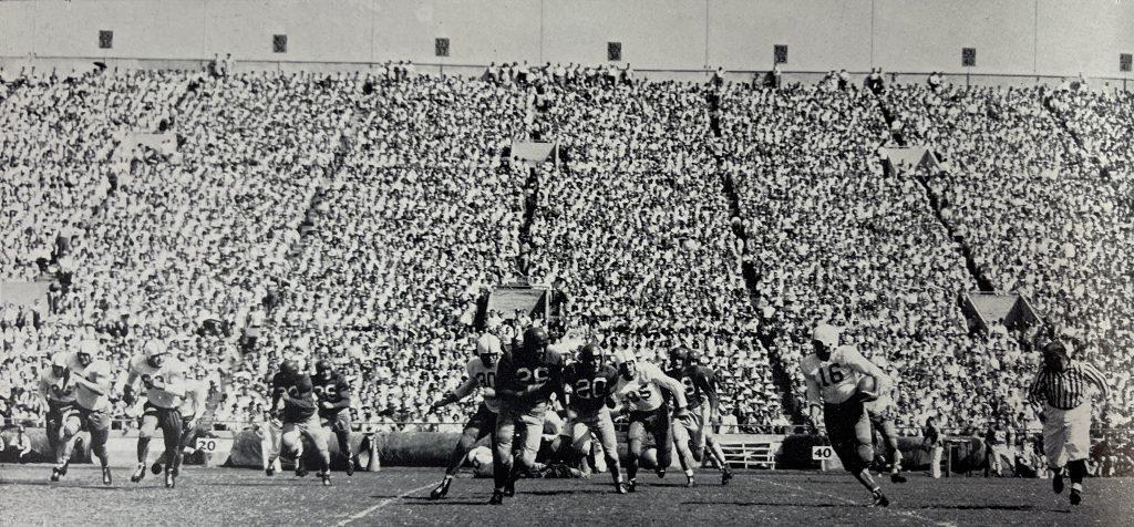 A black and white photo of the 1949 football game between the University of Texas Longhorns and the University of New Mexico.