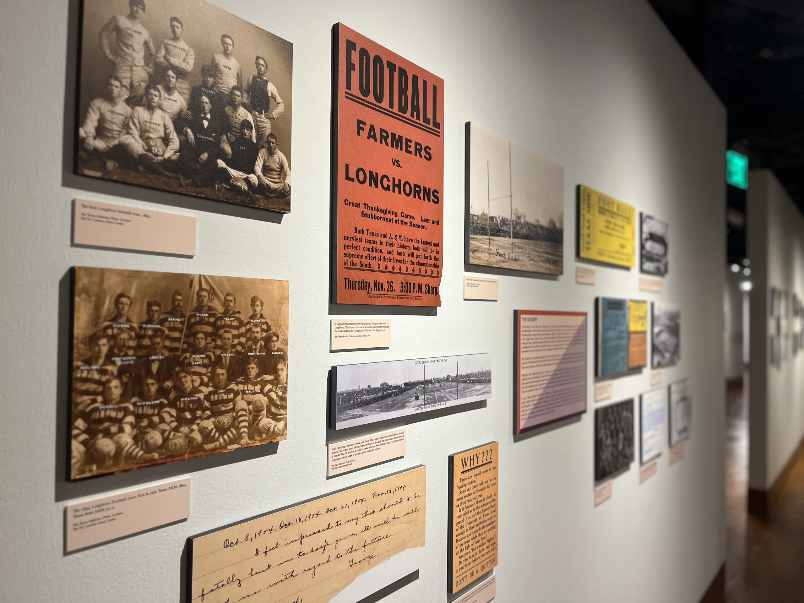 A color photograph of the history section of the new exhibit with black and white photos, reproductions of paper documents, and ticket stubs in full color.