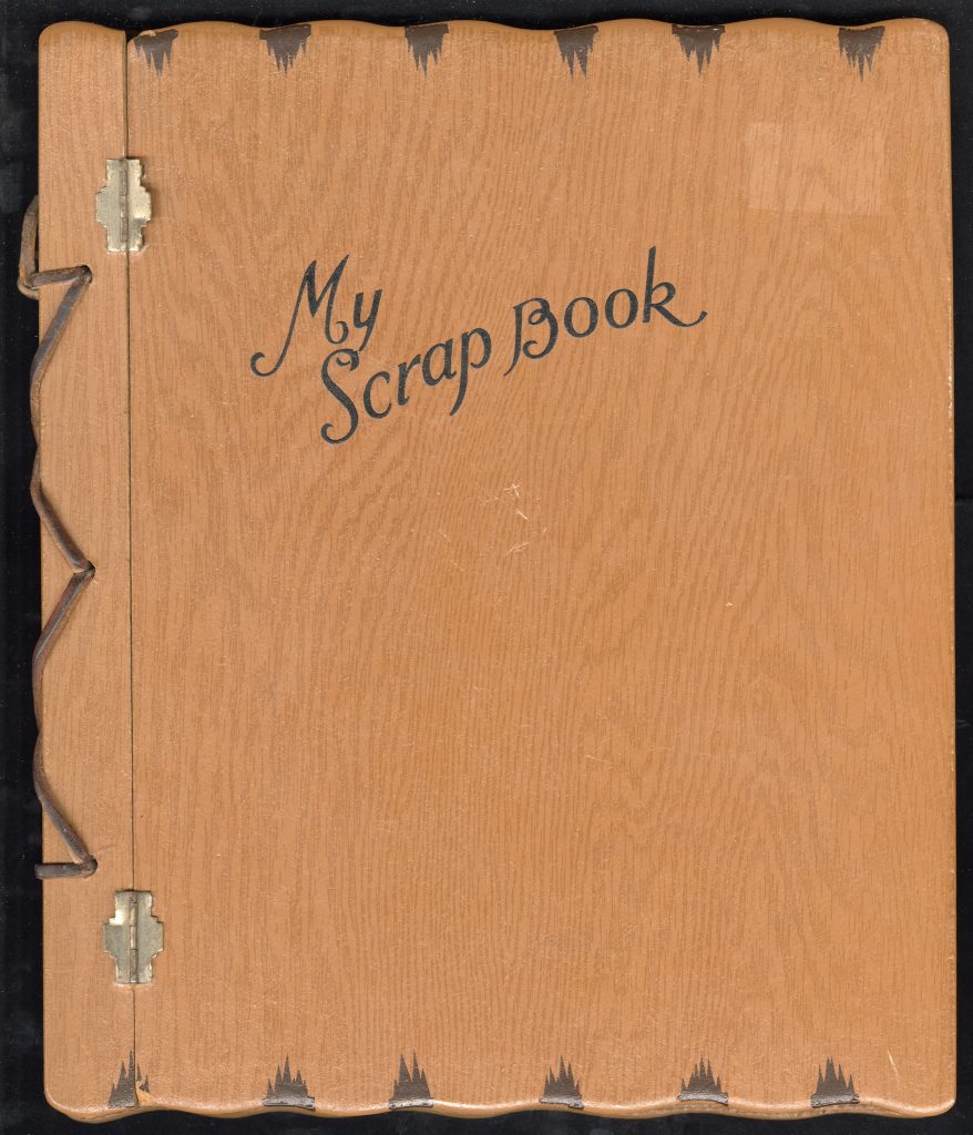 Brown wooden cover with leather laced and metal hinges with "My Scrapbook" on the image