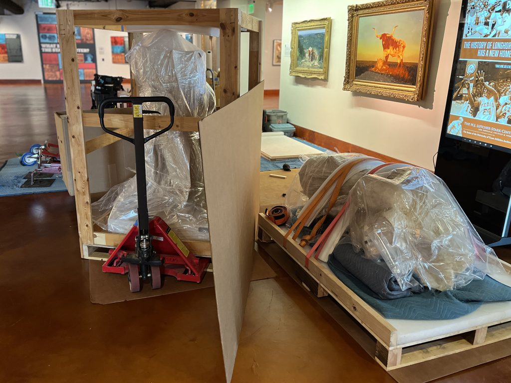 The crated halves of Winged Victory of Samothrace in the Stark Center lobby.