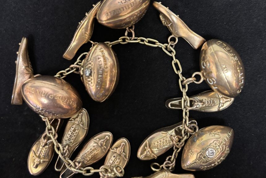 Clyde Littlefield's charm bracelet, adorned with Southwest Conference Championship charms, including footballs and track spikes.