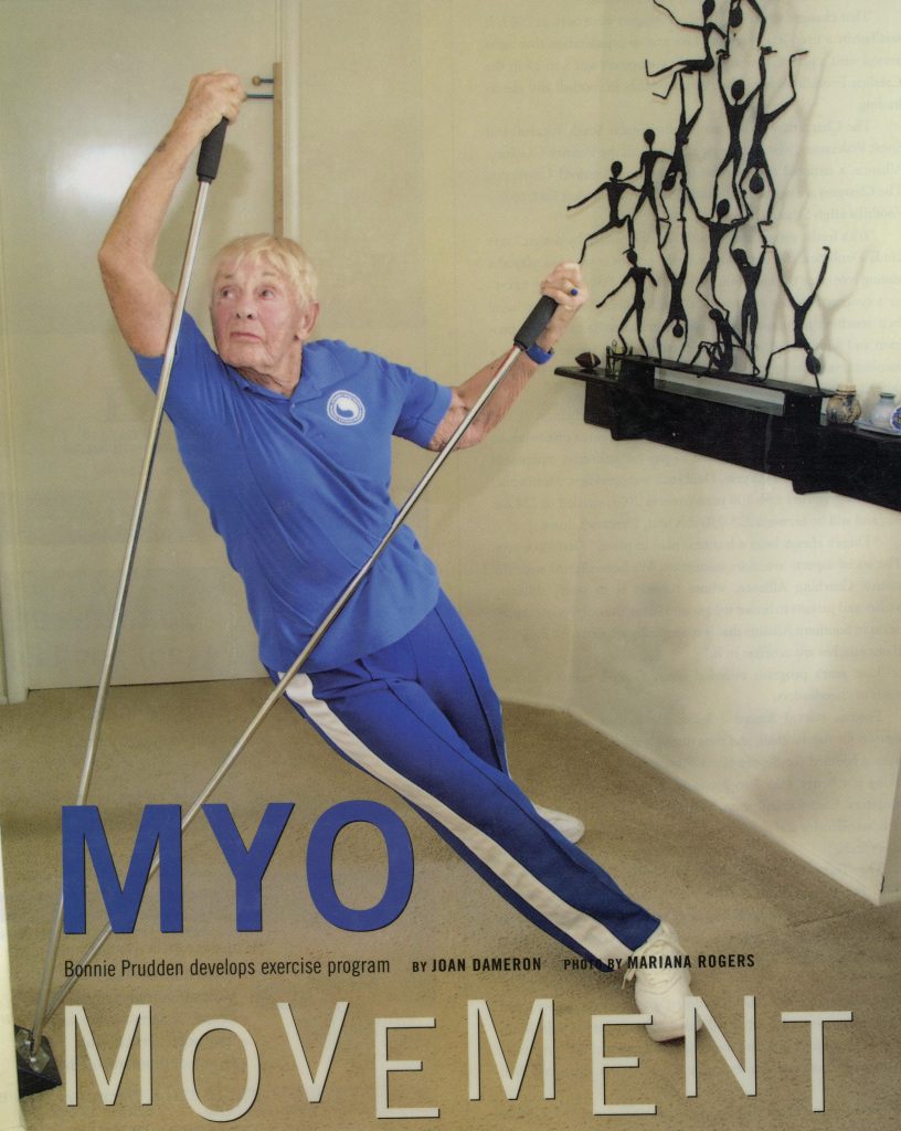 Bonnie stretching with picas poles on cover of magazine. 