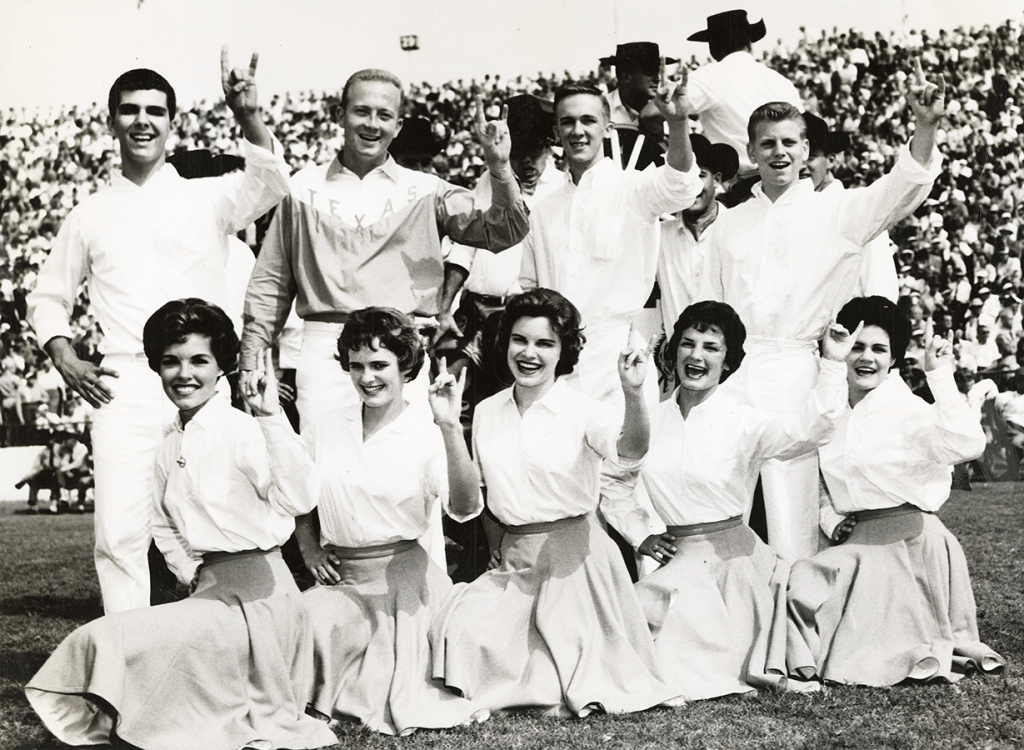 Black and white team photo of the University of Texas cheerleading team.
